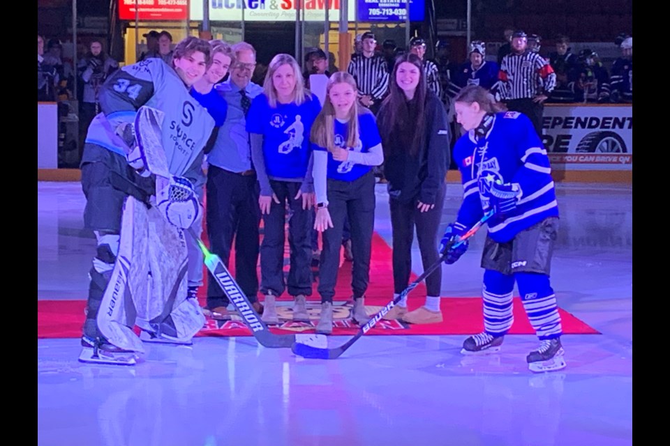 The Lyons family takes part in the ceremonial faceoff. Photo by Chris Dawson/Baytoday. 