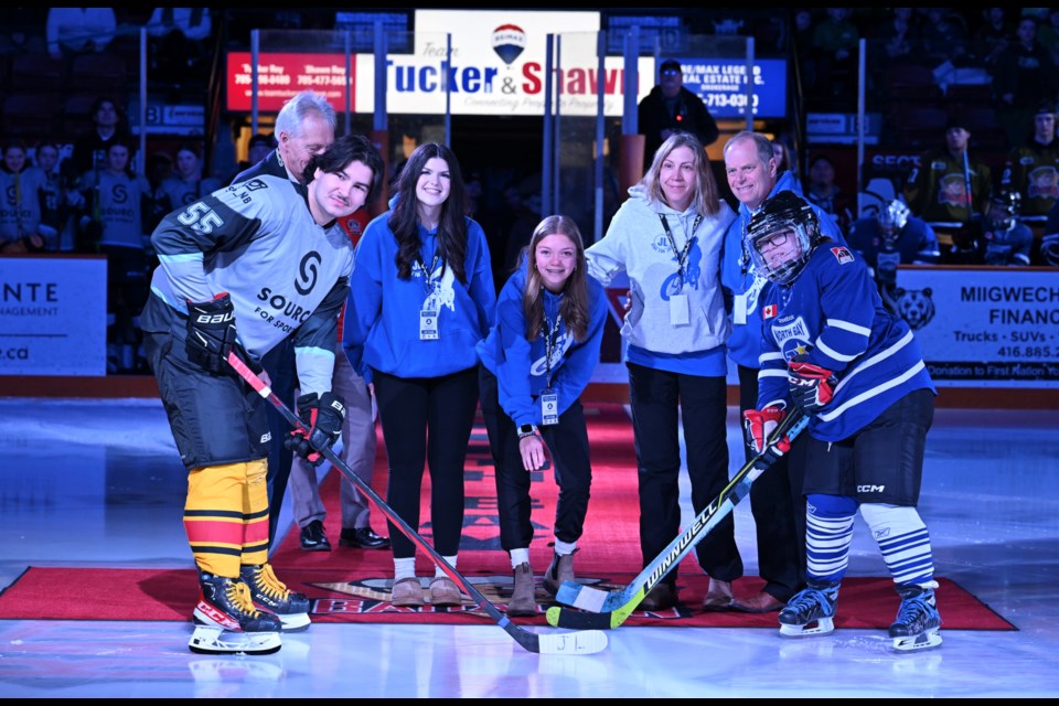 Ceremonial faceoff including the Lyons Family.  