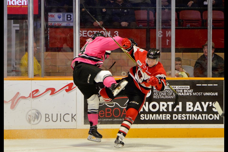 Bradley Chenier collides with an Ottawa 67's barber pole in the opening stanza. Photo by Tom Martineau. 