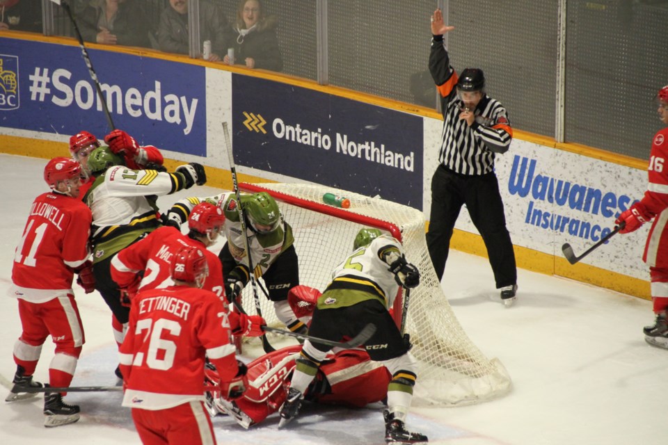 Luke Burghardt and Justin Brazeau dig for a puck covered by Greyhounds goalie Matthew Villalta.  Photo by Chris Dawson. 