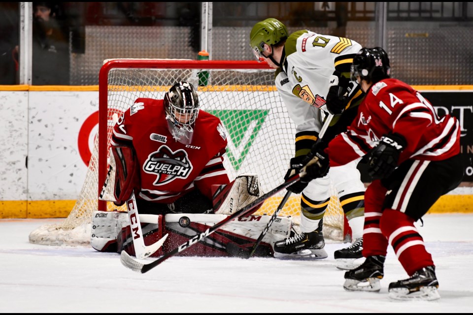 Guelph Storm goaltender Anthony Popovich makes a save on North Bay's Justin Brazeau in North Bay Sunday. Tom Martineau for BayToday.ca