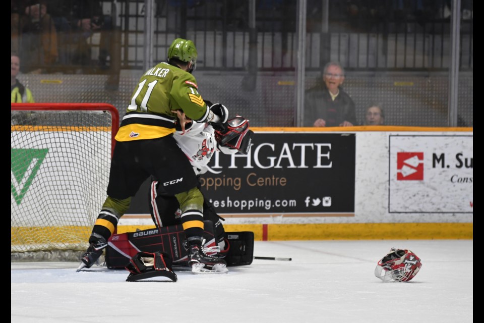 Daniel Walker and goalie Stephen Dhillon go toe to toe in the second period.  Photo by Tom Martineau/BayToday.ca. 
