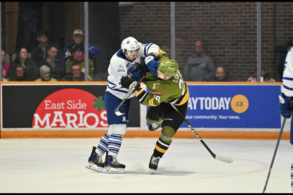 Alexander Lukin grapples with a Mississauga Steelheads player.  Photo courtesy Tom Martineau/BayToday. 