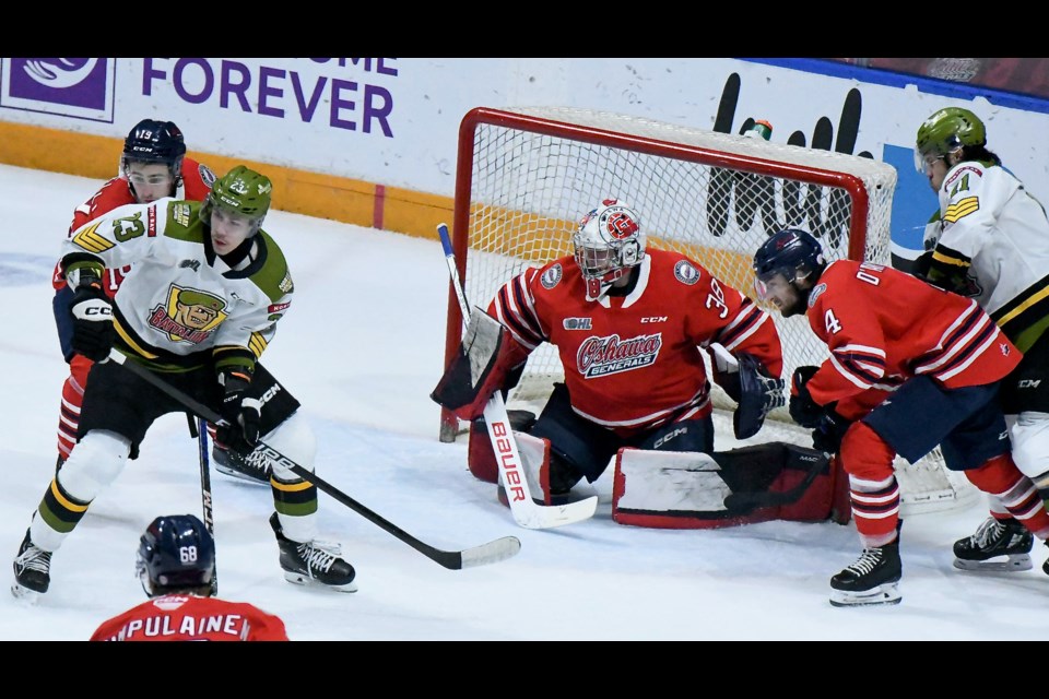 Battalion forward Sandis Vilmanis and Captain Liam Arnsby look for space in front of the Oshawa Generals net.