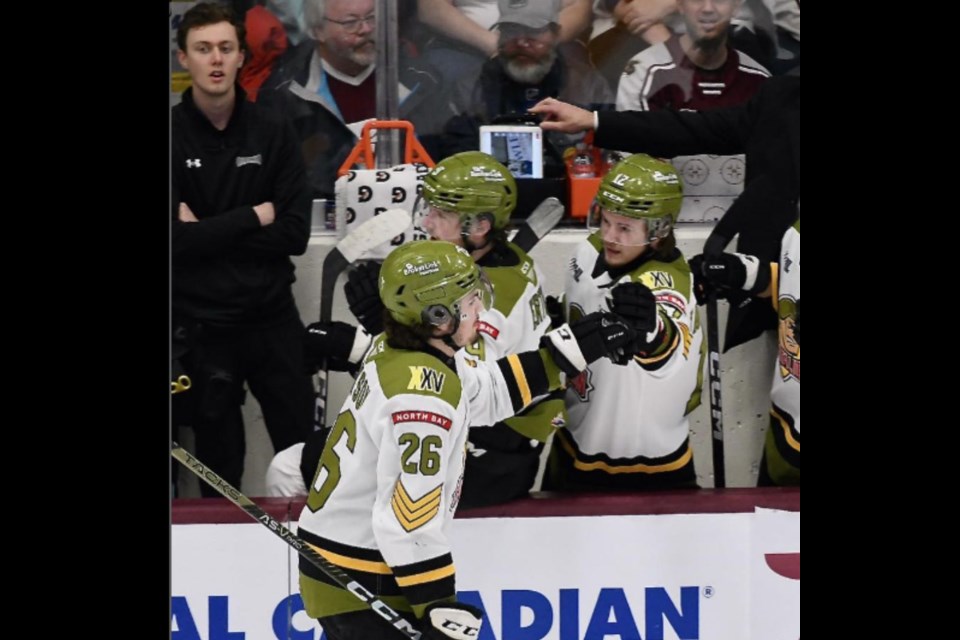 Mackenzie Campbell looks on from the bench as the North Bay Battalion celebrate a goal. Photo from Sean Ryan. 