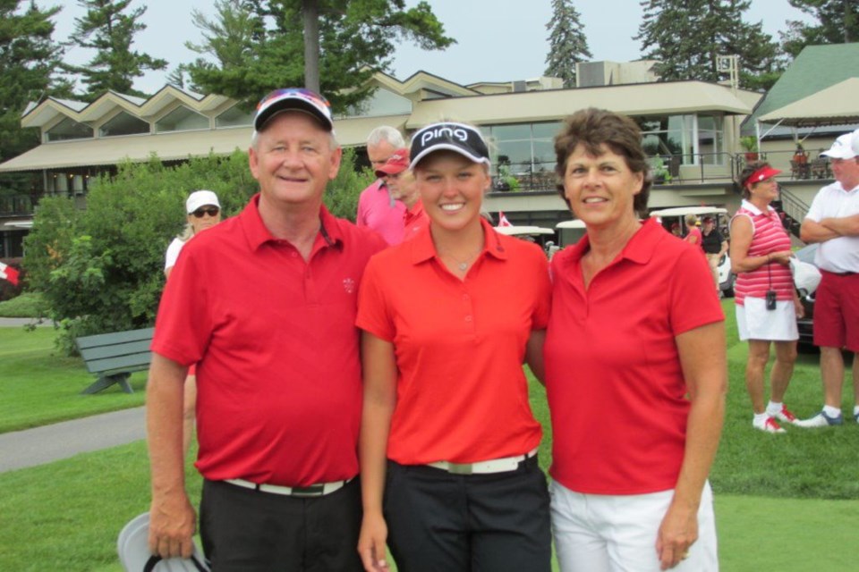 Guy Denis along with his wife Dianne, pose for a photo with Canadian Olympic Golfer Brooke Henderson. Photo submitted.  