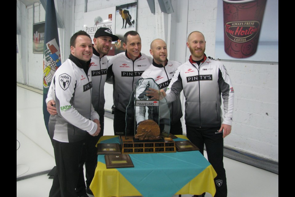 The Jacobs team of Skip Brad Jacobs, Ryan Fry, E.J. Harnden, and Ryan Harnden pose with the 2016 Travelers Northern Ontario championship trophy.  Photo by Jazz Mathon.  