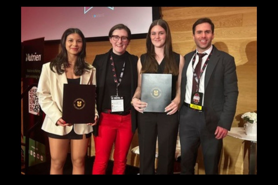 Lily George (left) and Mackenzie Keenan (middle right), accept their Frist Team All Canadian Awards (PHOTO Madison Tucker/UNB Athletics)