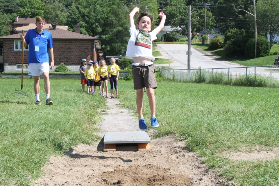 Youngsters work on the running long jump at the North Bay Legion summer track camp.  Photo by Chris Dawson. 