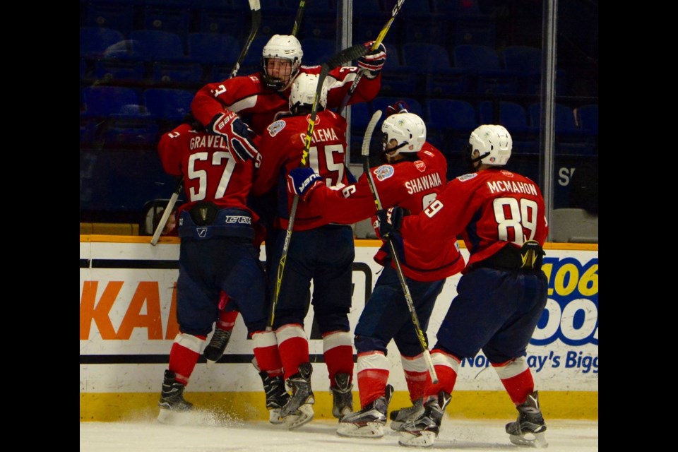Trappers celebrate a goal during action in game one of the Great North Midget League final earlier this month.  Photo by Tom Martineau.  