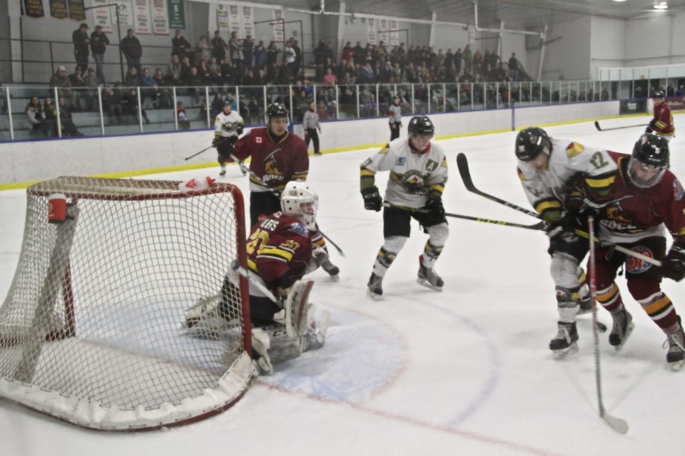 Voodoos battle for the puck at the edge of Timmins goalie Al Rogers crease. Photo by Chris Dawson. 