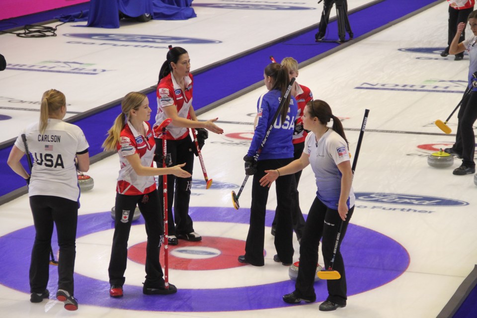 Team Canada and Team USA shake after a tight finish in the 10th.  Photo by Chris Dawson. 