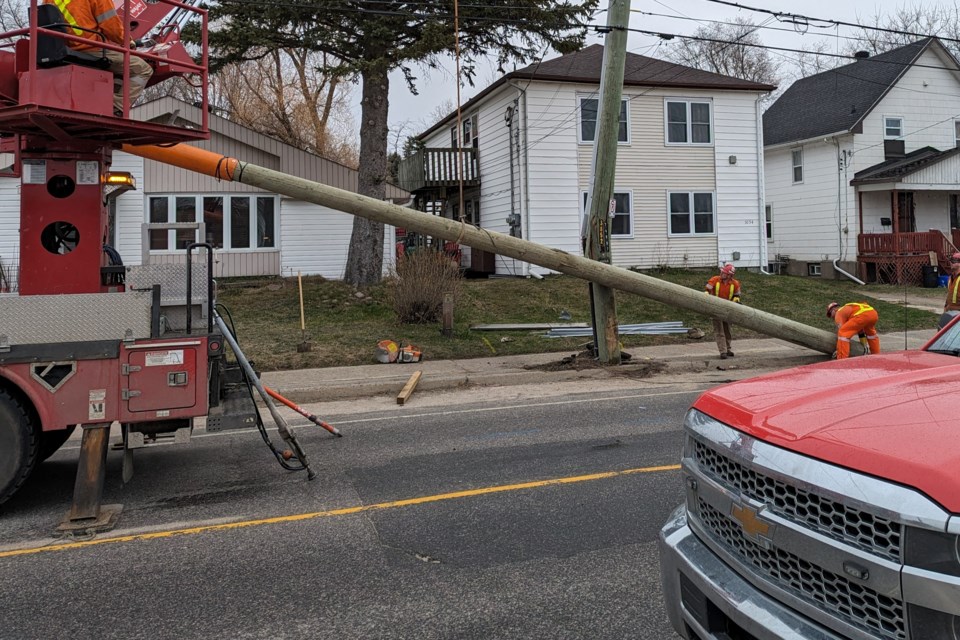 A North Bay Hydro crew replaces a pole following a collision Thursday morning.