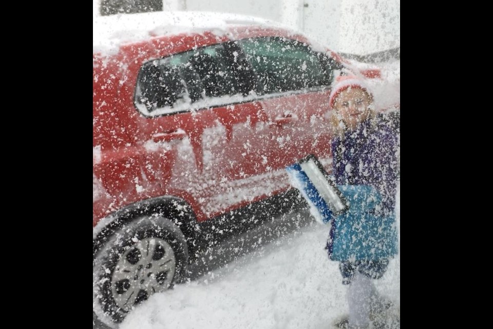 Lots of snow in North Bay today forcing the city to close Memorial Drive. Here, Payge Bowman brushes off her grandmother's car. Photo by Kristy Duquette.