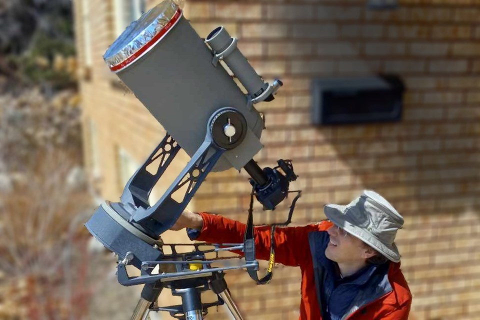Stephen Orlando fine-tunes his telescope for Monday's eclipse/