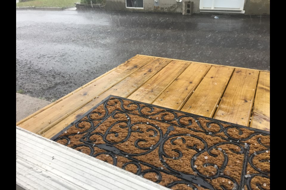 Hail stones the size of pebbles bouncing off this deck at a North Bay home on the north end of the city. Photo by Chris Dawson. 