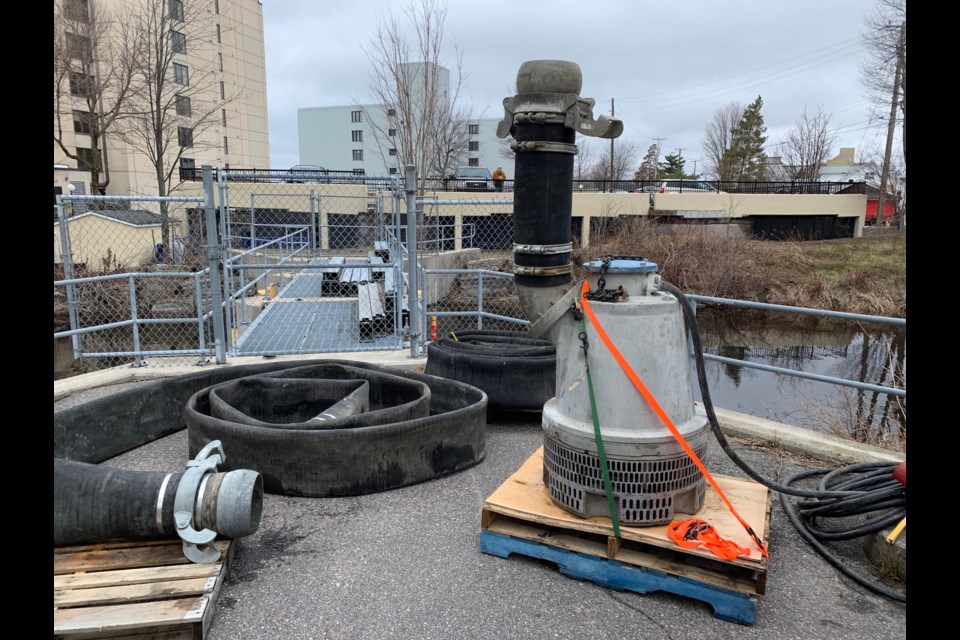 A huge submersible pump was lowered into Parks Creek this afternoon to augment the two existing pumps. The system is now fully operational. Jeff Turl/BayToday.