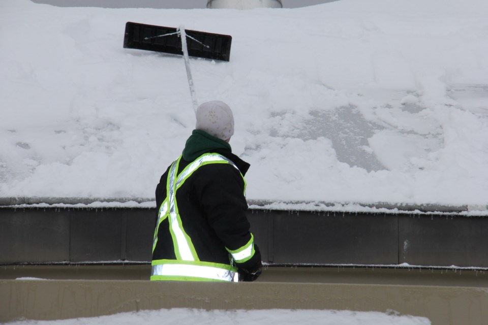 In this file photo, a snow rake is used to clear the roof of the West Ferris Arena. Photo by Jeff Turl.