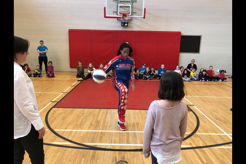 Harlem Globetrotter Lili "Champ" Thompson teaches ball handling tricks at the North Bay YMCA in advance of the April 1 game.
