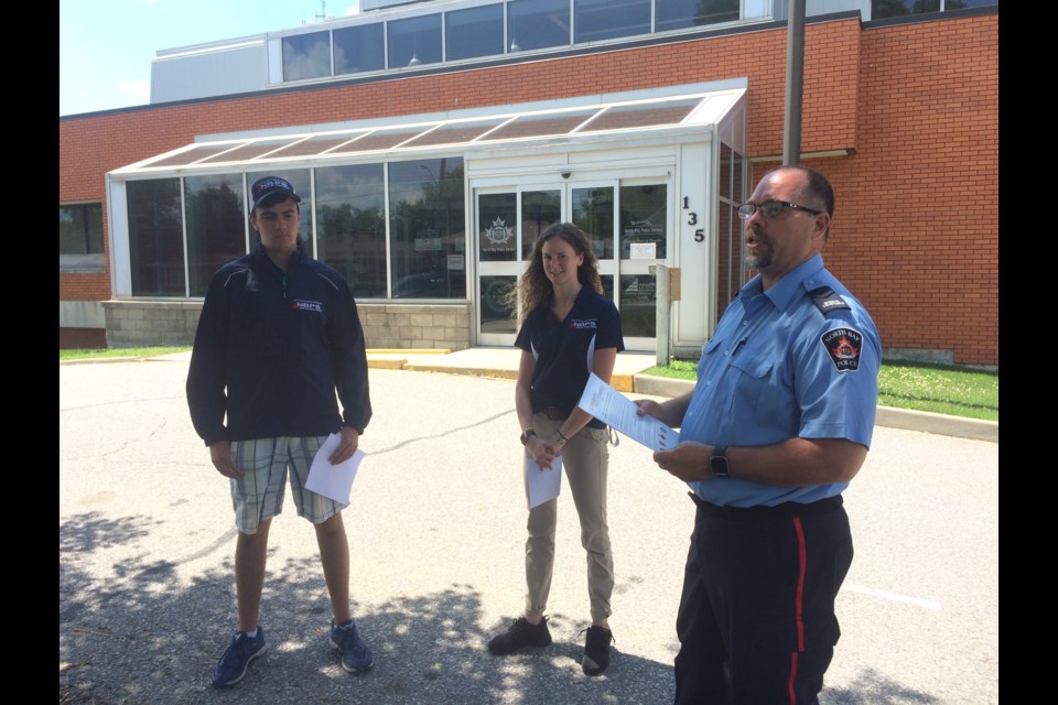 Youth In Policing Initiative (YIPI) students Sheldon Kilroy, Saida Wells  and Special Constable John Schultz Community Safety Coordinator discuss their summer projects under the program
Photo: Linda Holmes
Photo 