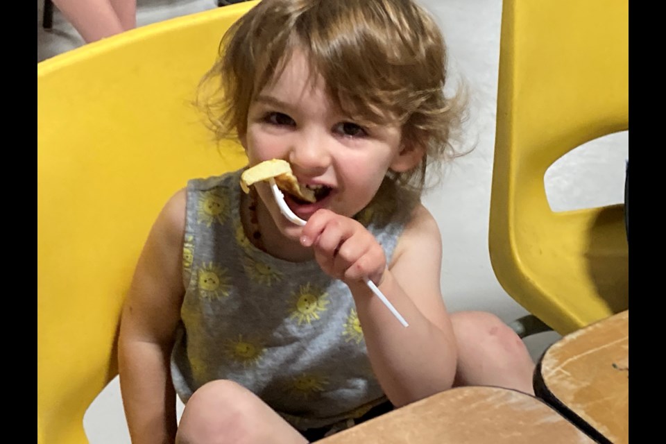 Two-year-old Brie Friese happily munches away on her pancake breakfast at Callander Funfest Canada Day celebrations.
