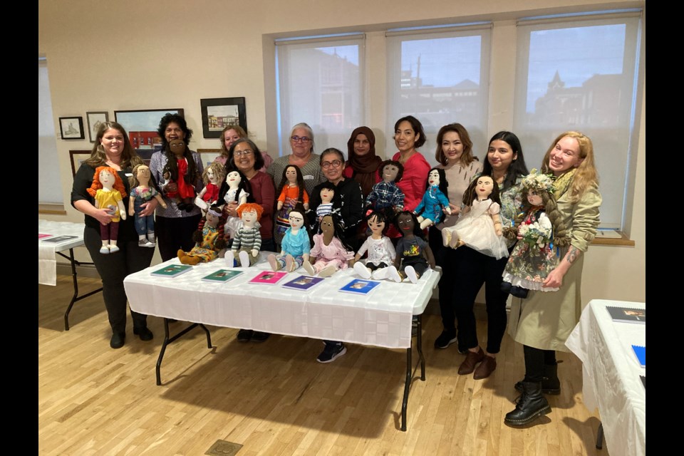 Doll makers hold doll they made for Unlearning Bias Using Persona Doll Project 