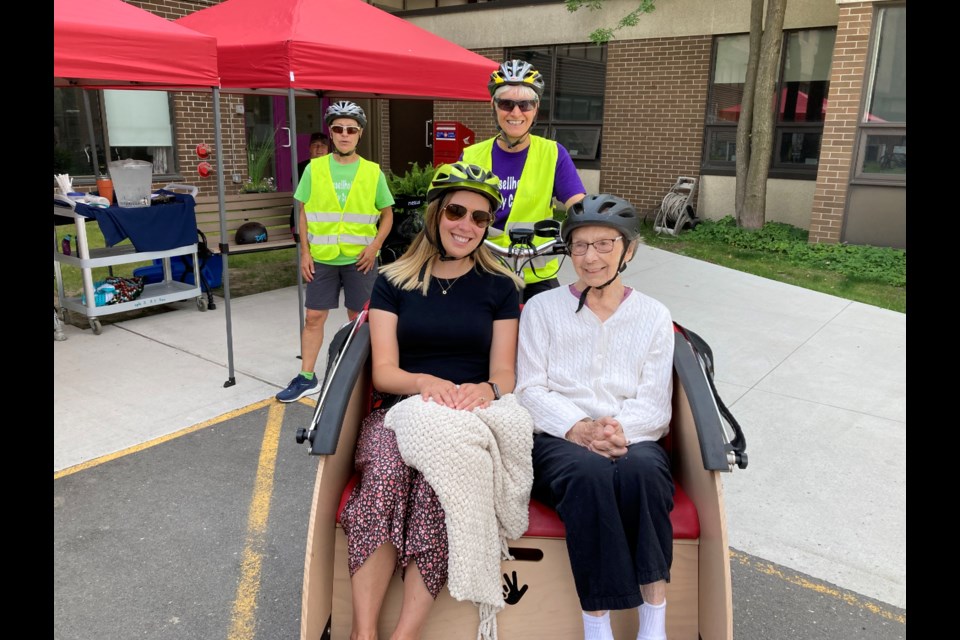 Trishaw riders (l-r) Alex McDermid, Milly Rogerson, and pilots Brenda Walsh sitting behind and Monique Peters standing. 