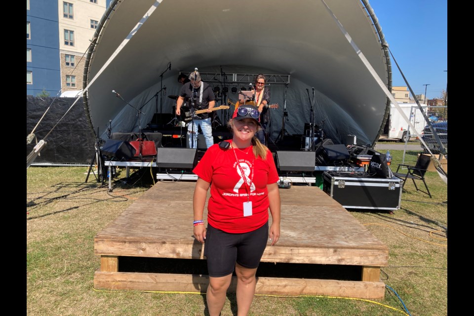 Paige Shemilt stands in front of one of a number of bands playing during Jordan's Bash for Hope honouring her husband's vision to raise money and awareness to help fight colon cancer. 