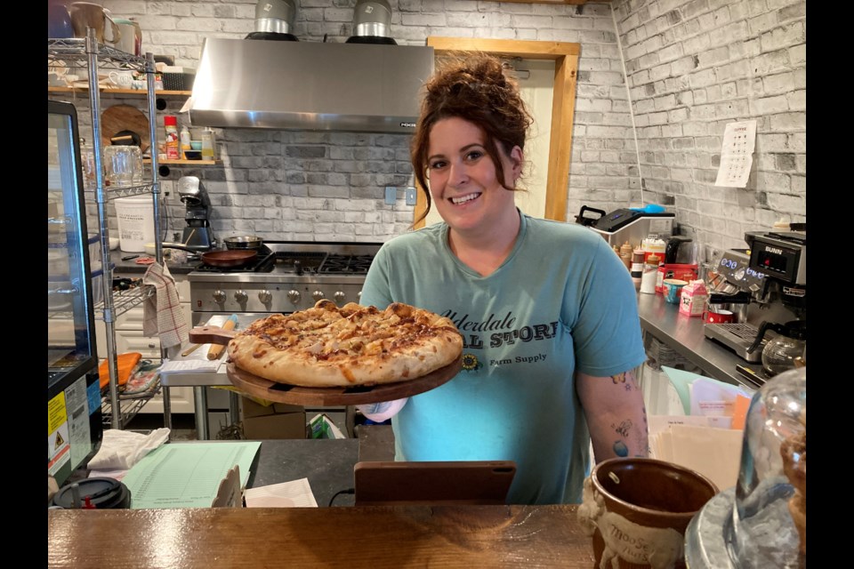 Owner of Alderdale General Store, Victoria Perron holds one of her famous pizzas