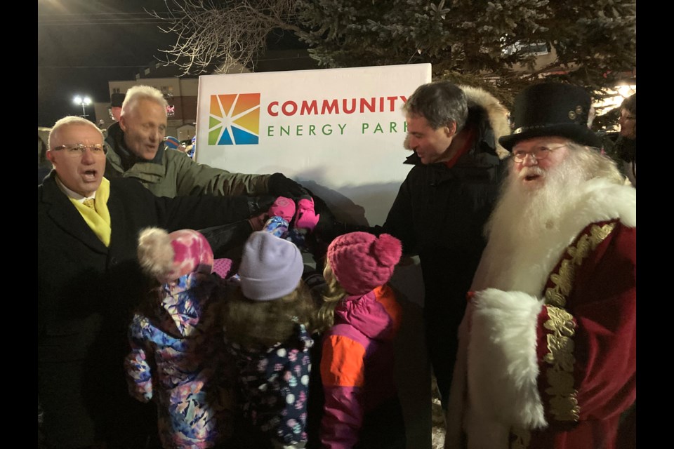 Local dignitaries flip the giant light switch to light the Christmas tree kicking off the Old Fashioned Christmas Walk