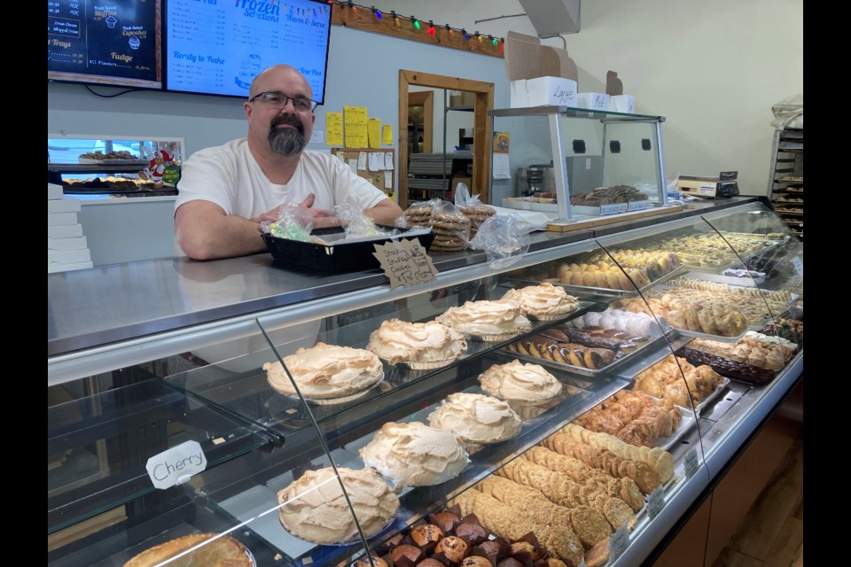 Owner Daniel Lelievre stands behind the counter at Chez Jean-Marc Bakery,
