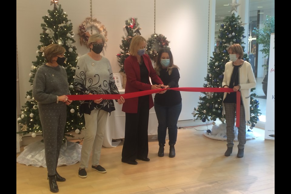 NBRHC Foundation President and CEO Tammy Morison (middle left) and PADDLE program executive director Megan Johnson (middle right) cut the ribbon to launch the 2021 Festival of Trees & All Things Christmas fundraiser