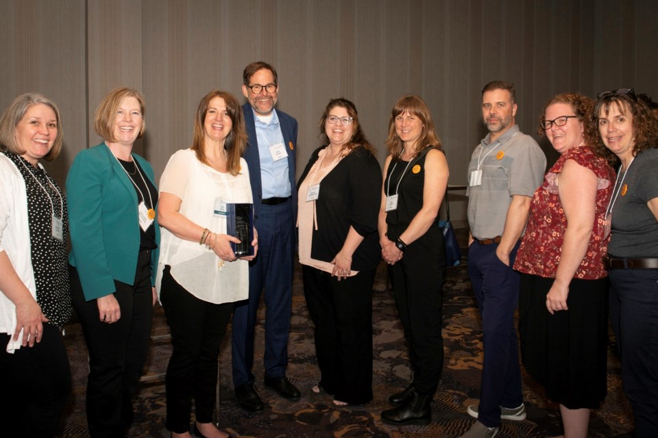Kara Macie (third from left) with her award for Literacy Leader of the Year