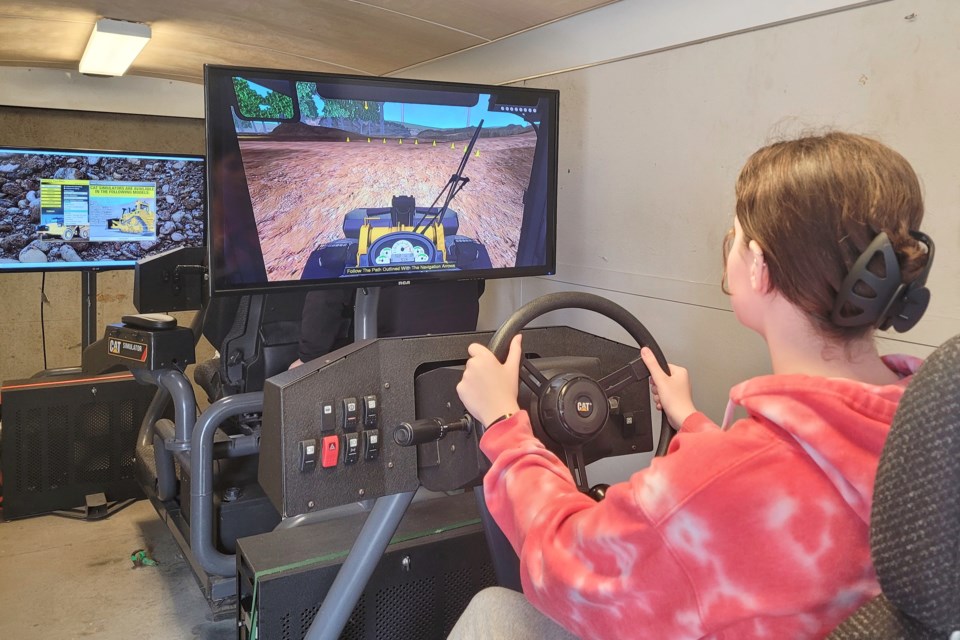 A student gives a front end loader  a run
