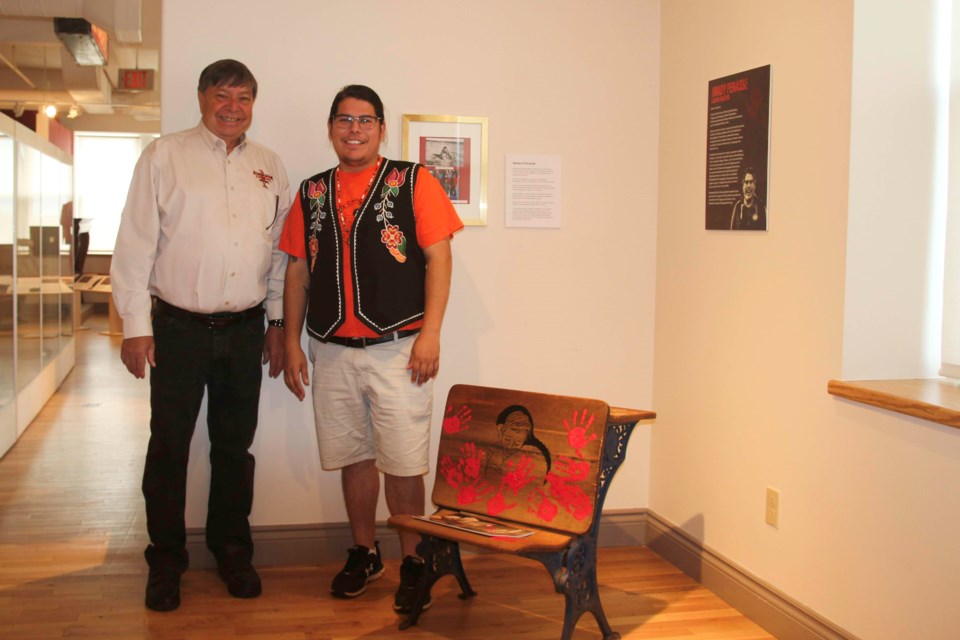 Exhibit organizer Les Couchi (left) with artist Brady Penasse