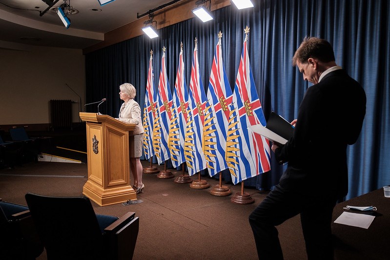 Bonnie Henry at podium - Adrian Dix