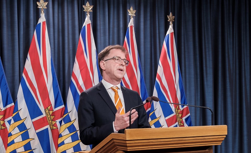 Adrian Dix with BC flags behind