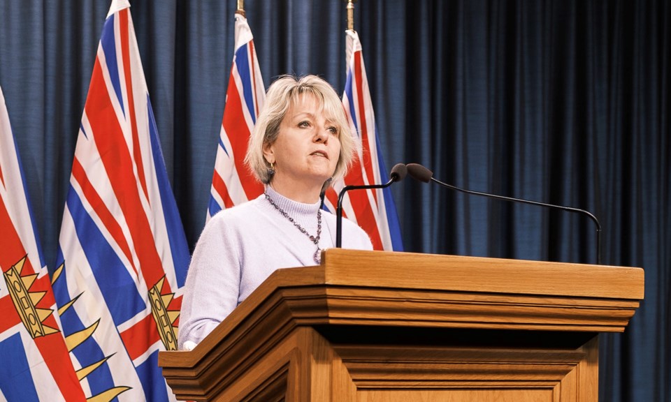 Bonnie Henry at podium in blue