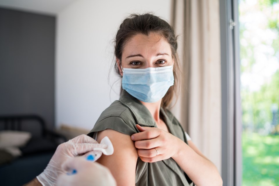 Woman mask vaccine - getty - halfpoint images