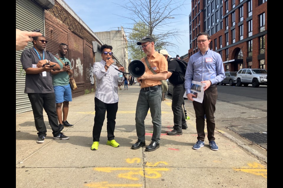 Council Member Crystal Hudson, flanked by representatives from WXY and various New York City agencies, speaks to a walking tour.