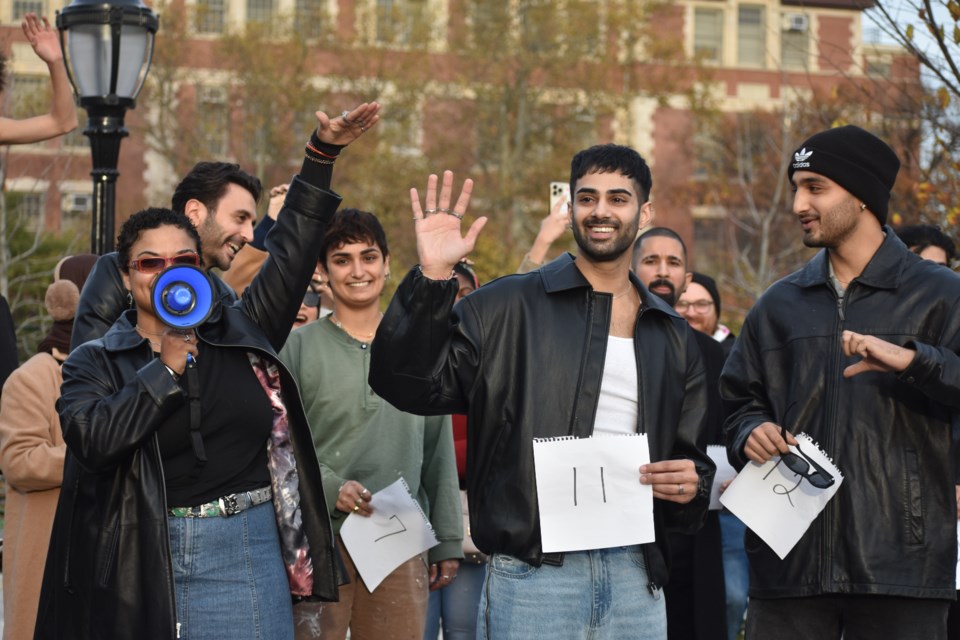 Shiv Patel, holding the number 11 sign, was the winner of the Zayn Malik lookalike contest held in Bushwick on Nov. 17, 2024.