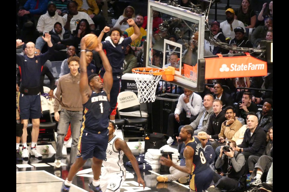 Zion Williamson flying in for a dunk.