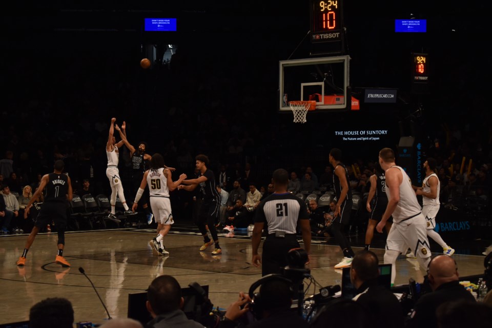 Michael Porter Jr. launches a three from the corner that is contested by Spencer Dinwiddie.