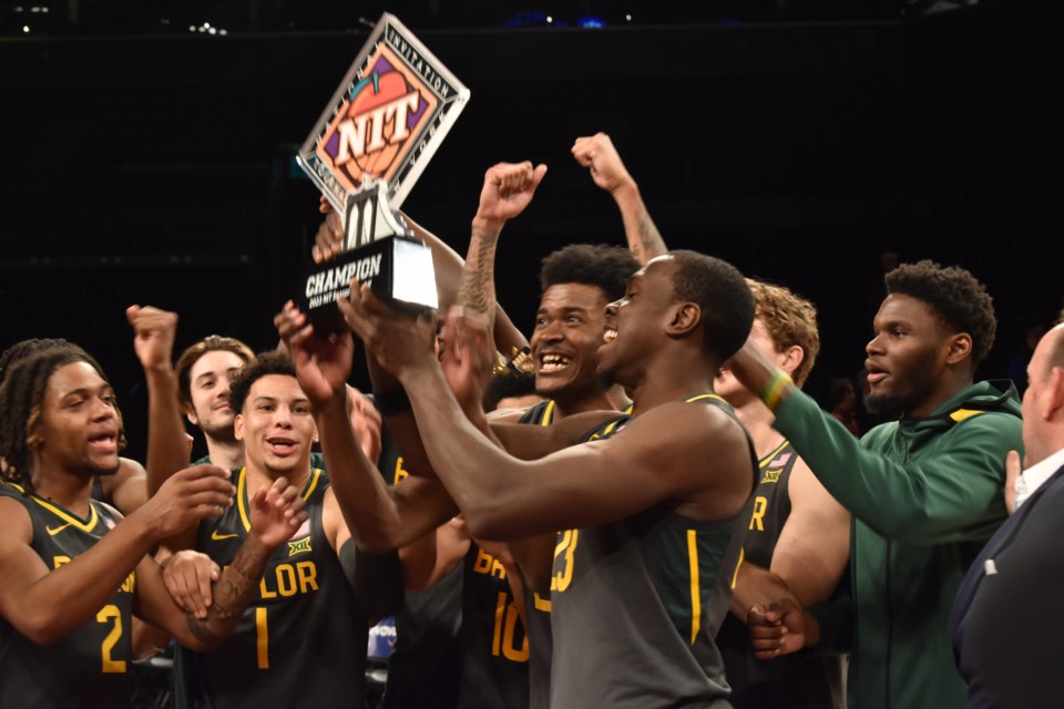 The Baylor team celebrates as champions of the NIT Season Tip-Off Tournament.