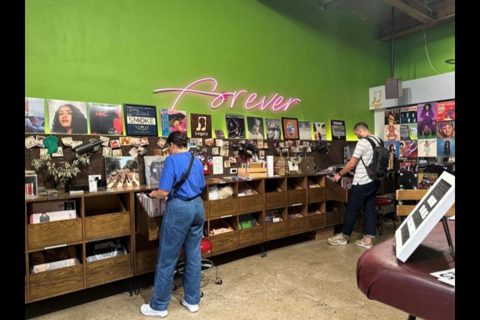 Customers look through Legacy's diverse vinyl collection.
