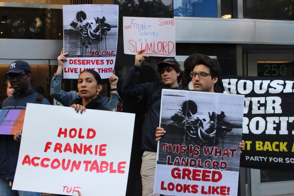 Ashley Saunders (right) and Peter Goldberg (left) protest the conditions of Saunders' apartment.