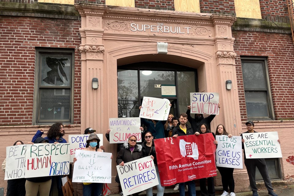 Tenants protest outside 974 47th St., a building damaged by a fire in October. Some tenants were forced to vacate their apartments, and the tenants say Maimonides has done little to repair the building