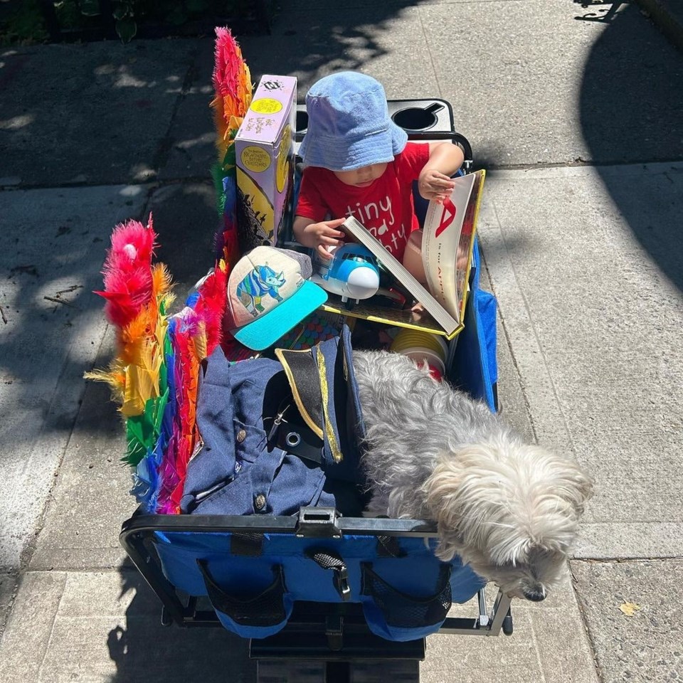 great-plg-stoop-and-sidewalk-sale_8-june-2024_child-in-wagon-with-sale-purchases