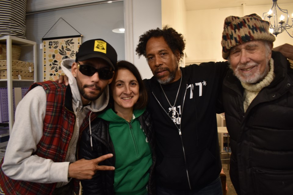 Miles McAfee wearing a 7 7 hoodie along with his wife, Vanessa Raptopoulos, and two 7 7 regulars, Melo (L) and Steve Slavin (R).
