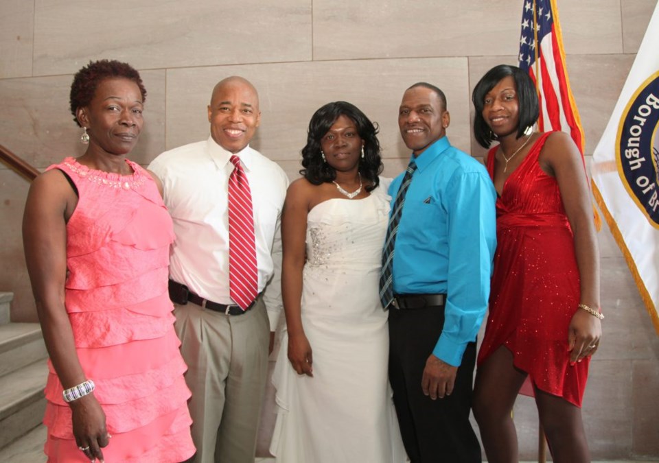 Brooklyn Borough President Eric Adams joins newlyweds Marcell and Troy Culbertson (center), as well as members of their family, as he opens up Borough Hall to just-married couples in celebration of Valentine's Day. Photo Credit: Kathryn Kirk/Brooklyn BP's Office